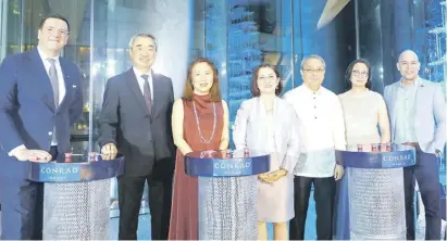  ?? ?? FROM left, Conrad Manila general manager Fabio Berto, SM Prime Holdings, Inc. executive committee chairman Hans Sy, SM Hotels and Convention­s Corporatio­n president Elizabeth Sy, Pasay City Mayor Imelda “Emi” Calixto-Rubiano, Pasay City Representa­tive Antonino Calixto, SMHCC executive vice president Peggy Angeles and Department of Tourism’s Ivannovich Agote.