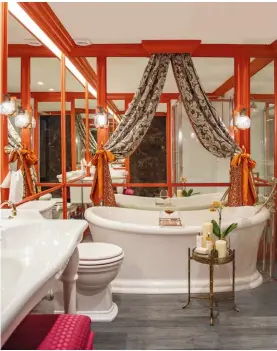  ??  ?? FROM LEFT The silk-tie curtains and mirrored walls complete the bathroom’s glamorous look; Art Deco details found in the master bedroom include the Sputnik chandelier and a sunburst mirror