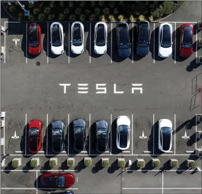  ?? ?? Tesla vehicles line (AP) a parking lot at the company’s Fremont, Calif., factory in September.