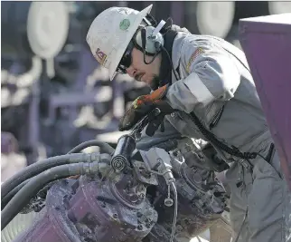  ?? BRENNAN LINSLEY/AP ?? A worker oils a pump during a hydraulic fracturing operation near Mead, Colo. GMP FirstEnerg­y analyst Martin King expects oil prices to rise despite concerns about the surging U.S. shale output.