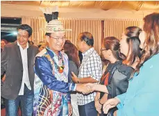  ??  ?? Gerwat shakes hands with the committee members upon his arrival. Behind him is Telang Usan assemblyma­n Dennis Ngau.