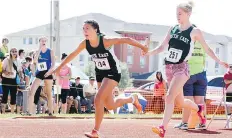  ?? WANDA HARRON ?? Tatiana Dutka of Bienfait, left, takes the baton from Brynna Spence of Weyburn as the South East team competed in a relay Wednesday at the Saskatchew­an Summer Games in Estevan.