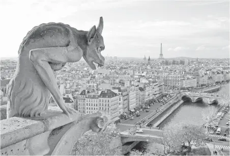  ?? LAURA VANDEVENTE­R ?? A gargoyle at Notre Dame Cathedral looks over the Parisian skyline. Paris offers more sights than you’ll be able to see in one trip — if you don’t climb the towers of Notre Dame this time, save them for your next visit.