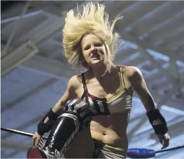  ??  ?? Xandra Bale, real name Alex Davidson, delivers a kick during her bout against Jessie Mack at the Oshawa Curling Club, near Toronto. Across the industry, attitudes toward female wrestlers are changing.