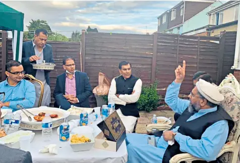  ??  ?? Cllr Tahir Malik, third left, with some of the other men at a gathering two days before Luton was named an “area of interventi­on” after a flare-up of Covid-19 cases