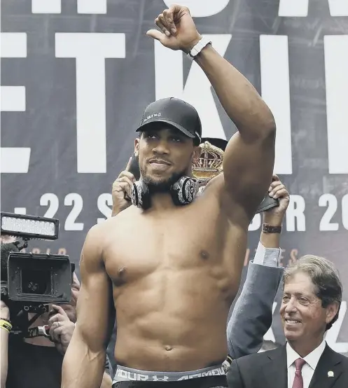  ??  ?? Anthony Joshua looks in the mood ahead of his fight with Alexander Povetkin, inset, who is ranked three in the world by Ring Magazine.