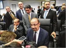  ?? STEFAN WERMUTH / BLOOMBERG ?? Khalid Al-Falih (center), Saudi Arabia’s energy and industry minister, speaks with reporters Thursday before OPEC’s decision to cut production by 800,000 barrels a day.