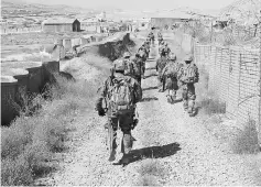  ??  ?? US military advisers from the 1st Security Force Assistance Brigade walk at an Afghan National Army base in Maidan Wardak province, Afghanista­n in this file photo. — Reuters photo