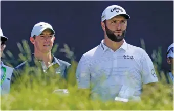  ?? AP PHOTO/ROBERT F. BUKATY ?? Rory McIlroy, left, and Jon Rahm talk before teeing off at the fifth hole at The Country Club during Monday’s practice round ahead of the U.S. Open golf tournament.