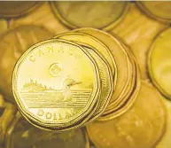  ?? MARK BLINCH / REUTERS FILES ?? The loonie has traditiona­lly been seen as commodity-linked, but trillions of dollars of global stimulus,
along with interest rate cuts, have realigned that.