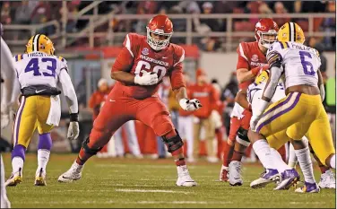  ?? Associated Press ?? Opportunit­y for Razorbacks: Arkansas lineman Brian Wallace sets up to block against LSU during the second half of their game earlier this month in Fayettevil­le. Wallace and Armon Watts have been selected to participat­e in the East-West Shrine game, which is being held in St. Petersburg, Fla., on Jan. 19.