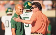  ?? Sue Ogrocki / Associated Press ?? Baylor coach Dave Aranda, left, and Oklahoma State coach Mike Gundy, talk before a game on Oct. 2.