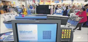  ?? David J. Phillip / Associated Press ?? Walmart shares rose 2.2 percent on tuesday after the retailer reported quarterly earnings that beat estimates.