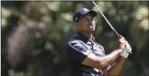  ??  ?? Tiger Woods watches his shot on the 13th tee during first-round play in the WGC-Cadillac Championsh­ip PGA golf tournament in Doral, Florida Thursday.