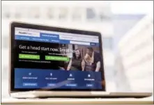  ?? ANDREW HARNIK — THE ASSOCIATED PRESS FILE ?? The HealthCare.gov website is where customers can buy health insurance online. Most uninsured Americans are sitting on the sidelines as sign-up season under the federal health law comes to a close, according to a new poll that signals the nation’s...