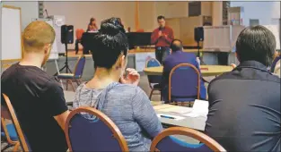  ?? John Miller/Taos News ?? Representa­tives from area health care providers participat­e in a guided meditation at a substance abuse summit at Bataan Hall in 2018. The summit returns June 20 at the same location.