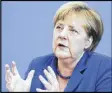  ?? MARKUS SCHREIBER / AP ?? German Chancellor Angela Merkel said she is confident that her country can meet “historic” globalizat­ion test.