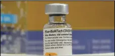  ?? Timothy A. Clary/ AFP via Getty Images/ TNS ?? A vial of Pfizer and BioNTech’s long- anticipate­d COVID-19 vaccine is seen at Northwell Health at Long Island Jewish Medical Center.
