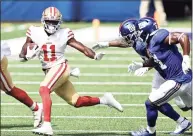  ?? Elsa / Getty Images ?? Brandon Aiyuk (11) of the San Francisco 49ers carries the ball as Jabrill Peppers (21) of the New York Giants pursues him at MetLife Stadium on Sunday in East Rutherford, N.J. The 49ers won 36-9.