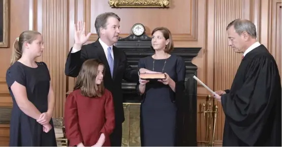  ??  ?? Chief Justice John G. Roberts Jr. administer­s the Constituti­onal Oath to new Supreme Court Justice Brett M. Kavanaugh on Saturday as Kavanaugh’s wife and daughters look on.