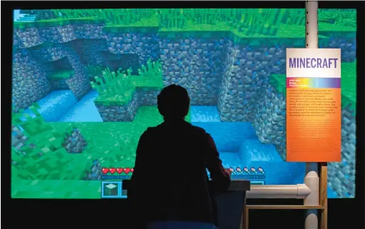  ?? KARSTEN MORAN/THE NEW YORK TIMES ?? A gaming enthusiast immersed in the world of Minecraft, a long-running hit on almost all digital platforms.