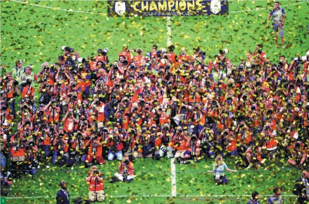  ?? LIU ZHANKUN / FOR CHINA DAILY ?? 1
1. Photojourn­alists zoom in on Germany’s national soccer team which won the FIFA World Cup in Rio de Janeiro, on July 12, 2014.