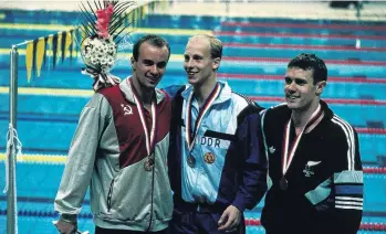  ??  ?? New Zealand bronze medallist Paul Kingsman celebrates on the podium with gold medallist Igor Poljanski, of the Soviet Union, and silver medallist Frank Baltrusch, of East Germany, after the 200m backstroke at the 1988 Seoul Olympics.
