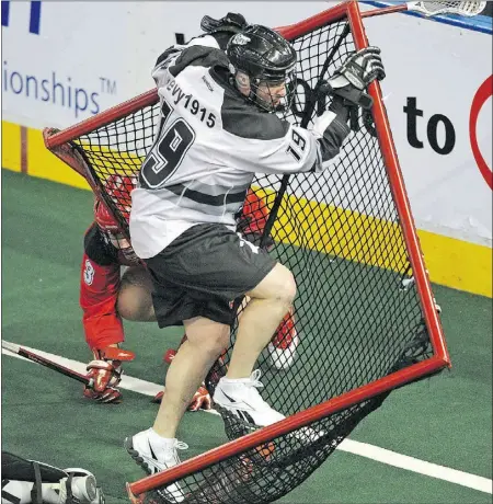  ?? Larry Wong, The Journal ?? Edmonton Rush’s Scott Evans collides with the Calgary Roughnecks net during NL action at Rexall Place on Friday.