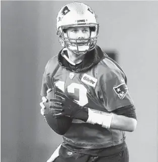  ?? MATT ROURKE/AP PHOTOS ?? New England Patriots quarterbac­k Tom Brady looks for a receiver during practice Friday in Atlanta as the team prepares for Super Bowl LIII against the Los Angeles Rams.