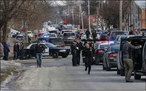  ?? AP/Daily Herald/BEV HORNE ?? Police block the street near the industrial valve plant in Aurora, Ill., where the shooting occurred Friday. Aurora Police Chief Kristen Ziman said officers responded quickly and were fired upon as soon as they entered the building.