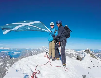  ??  ?? Jules Molyneaux and his dad, Chris, fly the Saltire from the summit of the Matterhorn.