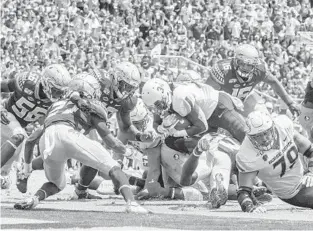  ?? MARK WALLHEISER/AP ?? Boise State Broncos running back Robert Mahone (34) dives for the end zone during his team’s win over Florida State on Saturday in Tallahasse­e.