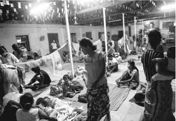  ??  ?? Photo shows ethnic Rakhine people, who escaped from unrest, taking a rest at a temporary shelter in Sittwe, Rakhine State. — AFP photo