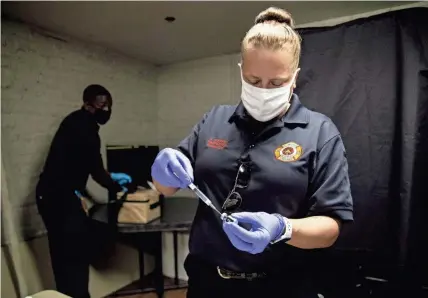  ?? ARIEL COBBERT/ COMMERCIAL APPEAL ?? Katrina Stewart of the Memphis Fire Department draws the COVID-19 vaccine into a syringe at Serenity Recovery Center on
April 28. The average new daily COVID-19 case rate in Shelby County has quadrupled from a month ago, officials said this week, and unvaccinat­ed people account for the overwhelmi­ng majority of hospitaliz­ations.