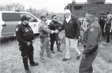  ?? DOUG MILLS The New York Times ?? President Donald Trump shakes hands with a U.S. Customs and Border Protection officer as he visits the Rio Grande in McAllen, Texas, on Thursday. Trump said ‘if for any reason we don’t get this going’ — an agreement with House Democrats who have refused to approve the $5.7 billion he demands for a border wall — ‘I will declare a national emergency.’