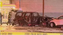  ?? 13 WHAM Tv/associated Press ?? Rochester, N.Y., firefighte­rs investigat­e the crash site after a man in an SUV loaded with gas cans sped toward a pedestrian crossing. He hit a vehicle first, killing two of its passengers.