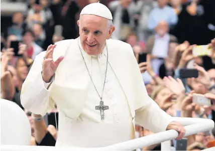  ??  ?? Pope Francis greets the public as he travels through Dublin in the Popemobile yesterday