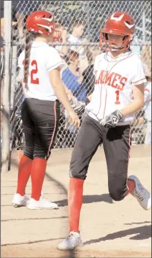  ?? MIKE BUSH/NEWS-SENTINEL ?? Above: Lodi runner Ashlee Toy touches home plate in Thursday's TCAL and crosstown softball game against Tokay. Toy and the Flames did not toy around on offense, which led to a 12-2 win over the Tigers. Watching the action is Lodi's Shelby Feathersto­n...