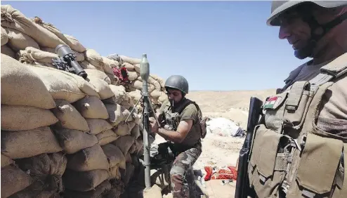  ?? SAFIN HAMED / AFP / GETTY IMAGES FILES ?? Iraqi Kurdish Peshmerga fighters at the front line against Islamic State militants. Canada wants assurances that any lethal aid sent to Kurdish forces will be used only against ISIL, and not in any bid for independen­ce from Iraq.