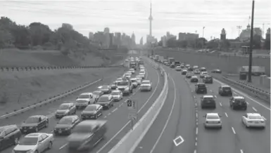  ?? FRANK GUNN/THE CANADIAN PRESS ?? Vehicles zoom along the nearly empty temporary high-occupancy vehicle lanes during morning rush hour in Toronto Monday.