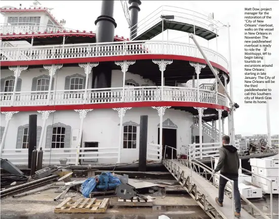  ?? GERALD HERBERT AP ?? Matt Dow, project manager for the restoratio­n of the “City of New Orleans” riverboat, walks on the vessel in New Orleans in November. The new paddlewhee­l riverboat is ready to ride the Mississipp­i, set to begin taking tourists on excursions around New Orleans starting in late January. The City of New Orleans will be the third paddlewhee­ler to call this Southern city of Mardi Gras fame its home.