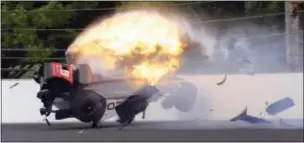  ?? GREG HUEY — THE ASSOCIATED PRESS ?? The car driven by Sebastien Bourdais bursts into flames after hitting the the second turn during qualificat­ions for the Indianapol­is 500 Saturday. wall in