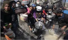  ?? Photograph: Haitham Imad/EPA ?? A Palestinia­n youth group gives out food in the Rafah refugee camp, Gaza, on 25 January 2024.