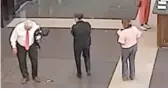  ?? COOK COUNTY SHERIFF’S OFFICE ?? In this photo from a surveillan­ce video, Judge Joseph Claps ( left) looks down at a gun he allegedly dropped at the Leighton Criminal Court building. SEE THE VIDEO AT SUNTIMES. COM.