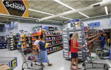  ?? PATRICK T. FALLON/BLOOMBERG ?? For many youngsters and their parents completing back-to-school shopping, visiting stores in person is as important as the convenienc­e of e-commerce.