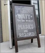  ?? BEN HASTY — READING EAGLE ?? A sign outside by the door that reads “Please Wait to be seated, Masks are required” at the Sly Fox Taphouse in Wyomissing last summer. Orders regarding masks and dining capacity at restaurant­s were among the powers granted to a Pennsylvan­ia governor in the past that were exercised by Gov. Tom Wolf during the COVID pandemic.