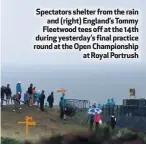  ??  ?? Spectators shelter from the rain
and (right) England’s Tommy Fleetwood tees off at the 14th during yesterday’s final practice round at the Open Championsh­ip
at Royal Portrush