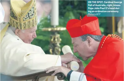  ?? Picture:AFP ?? ON THE SPOT. Cardinal George Pell of Australia, right, kisses Pope John Paul II’s hand during an ordination ceremony.