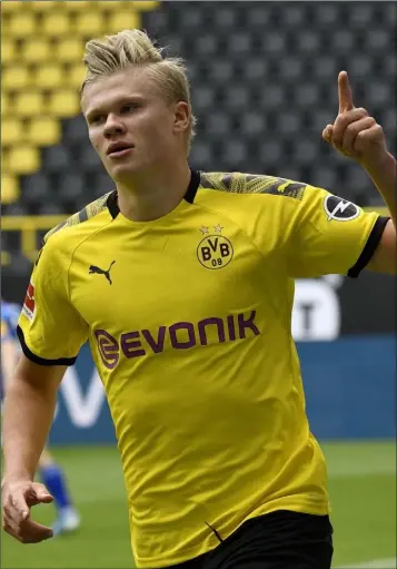  ??  ?? Erling Haaland celebrates in front of empty stands after scoring for Borussia Dortmund in their 4-0 win over Schalke on Saturday.