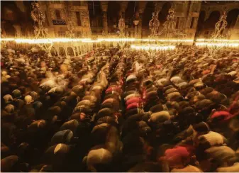  ?? Emrah Gurel / Associated Press ?? Muslim worshipers on Friday perform evening prayers, or tarawih, on the eve of the first day of the holy fasting month of Ramadan at the Grand Hagia Sophia Mosque in Istanbul.